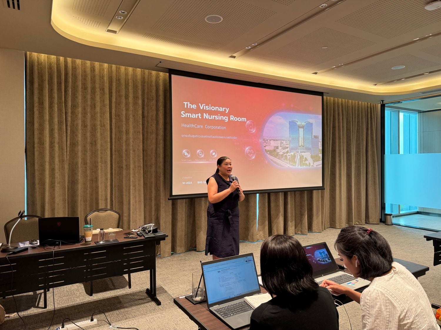 Employees seated at a workplace health education session led by W-Asia